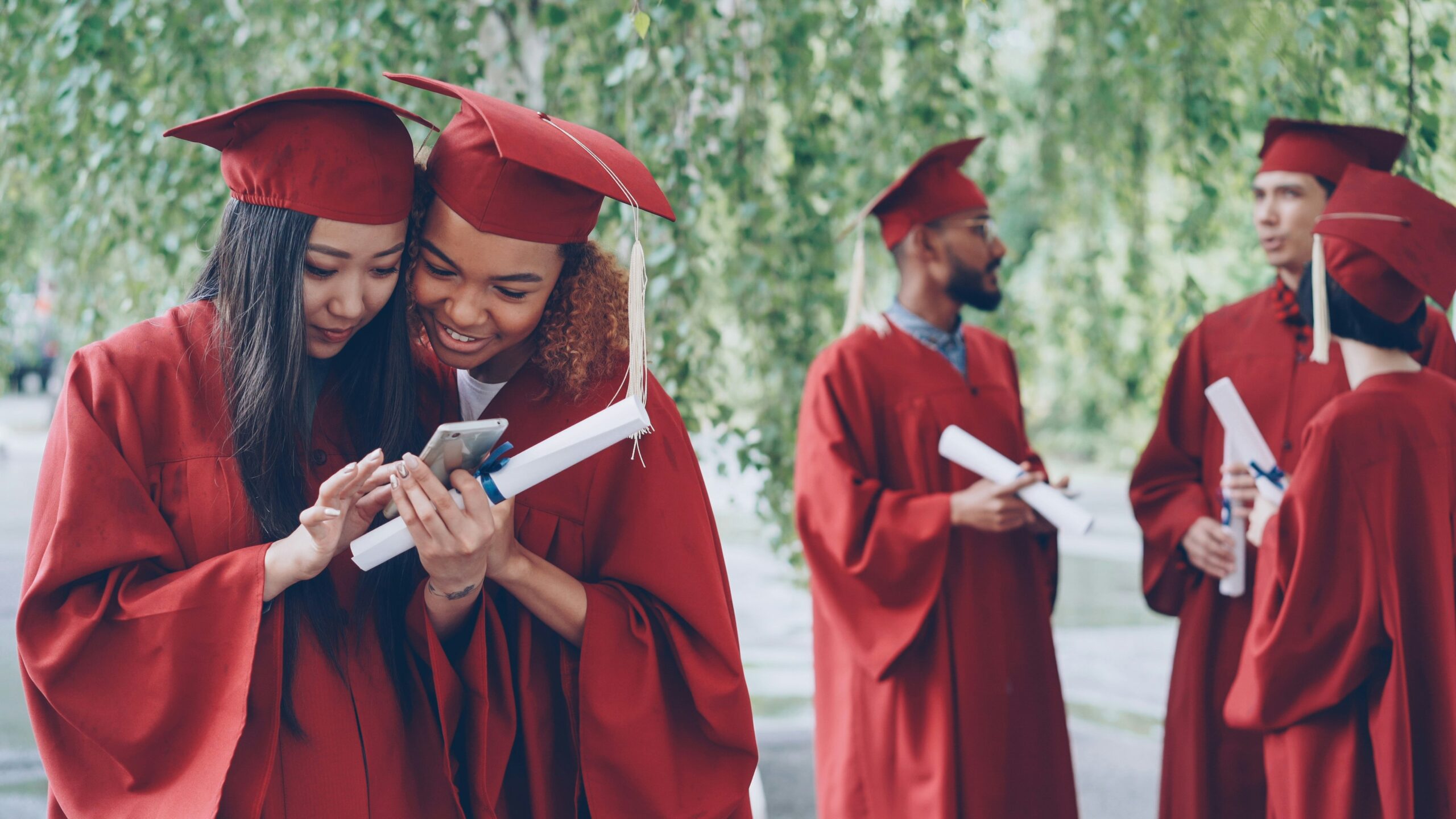 University graduates checking a result on a smartphone; illustrative featured image for NU On-Campus BBA Result 2026